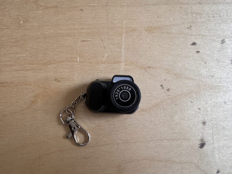 a keychain camera on a wood surface